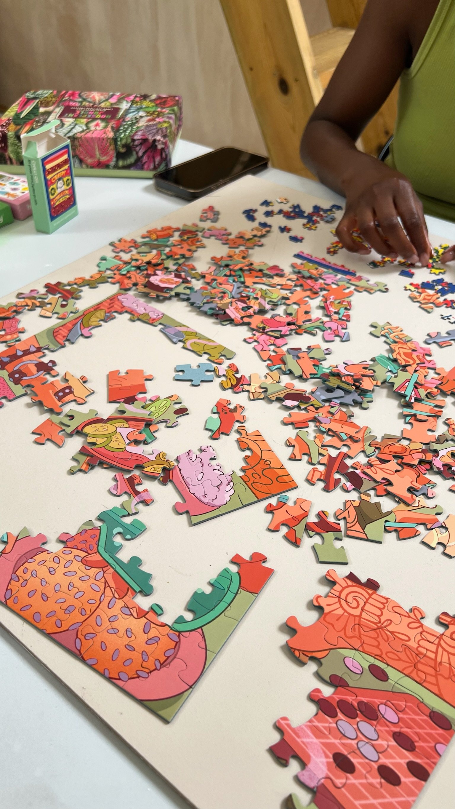 Hands sorting puzzle pieces on the table