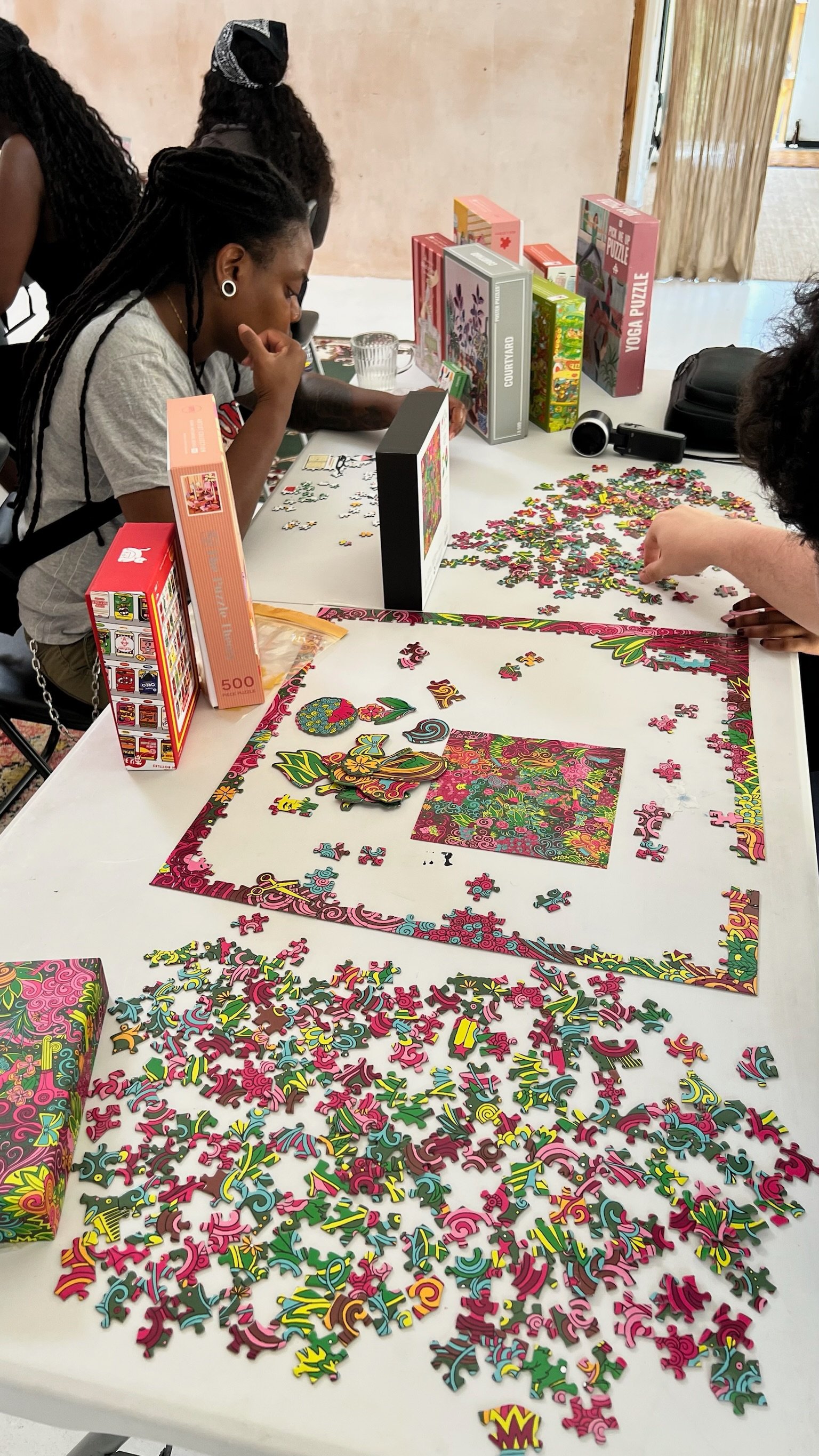 A floral puzzle in progress surrounded by mini puzzle boxes