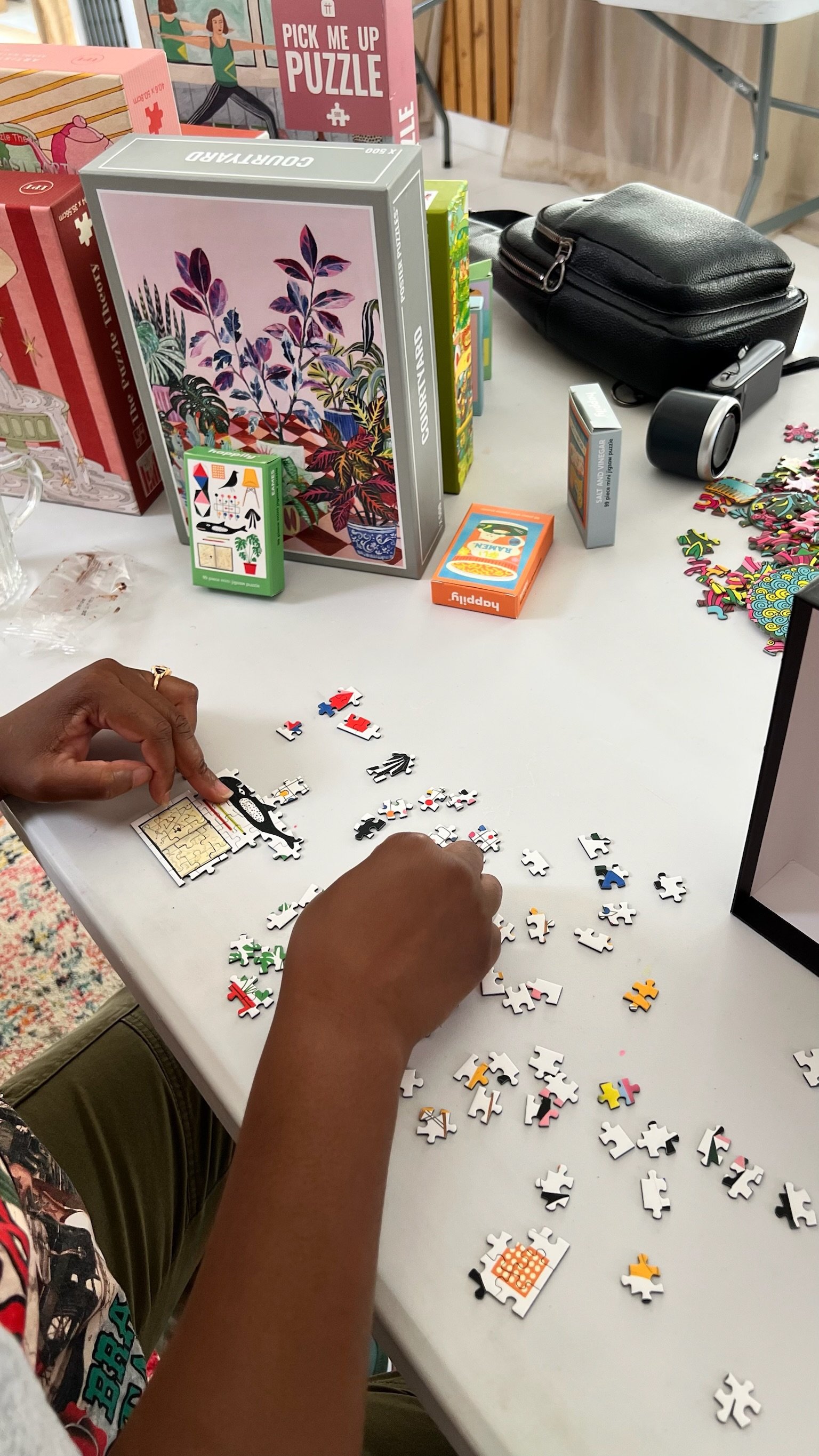 Close-up of hands piecing together a mini puzzle
