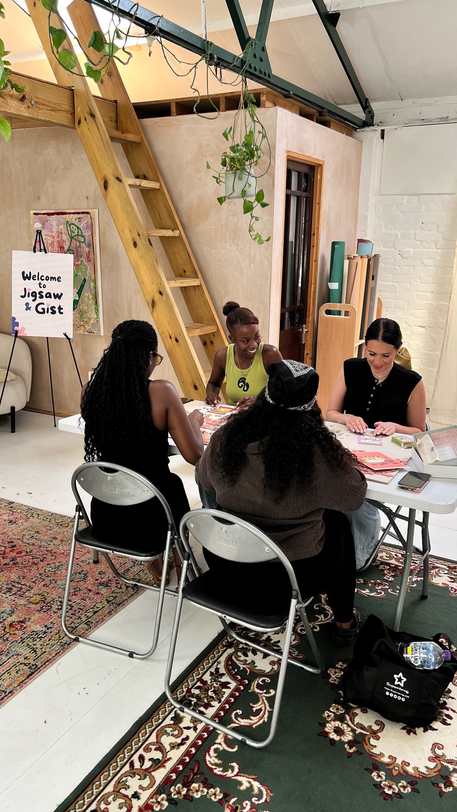 Overhead view of a group working on a puzzle near the loft ladder