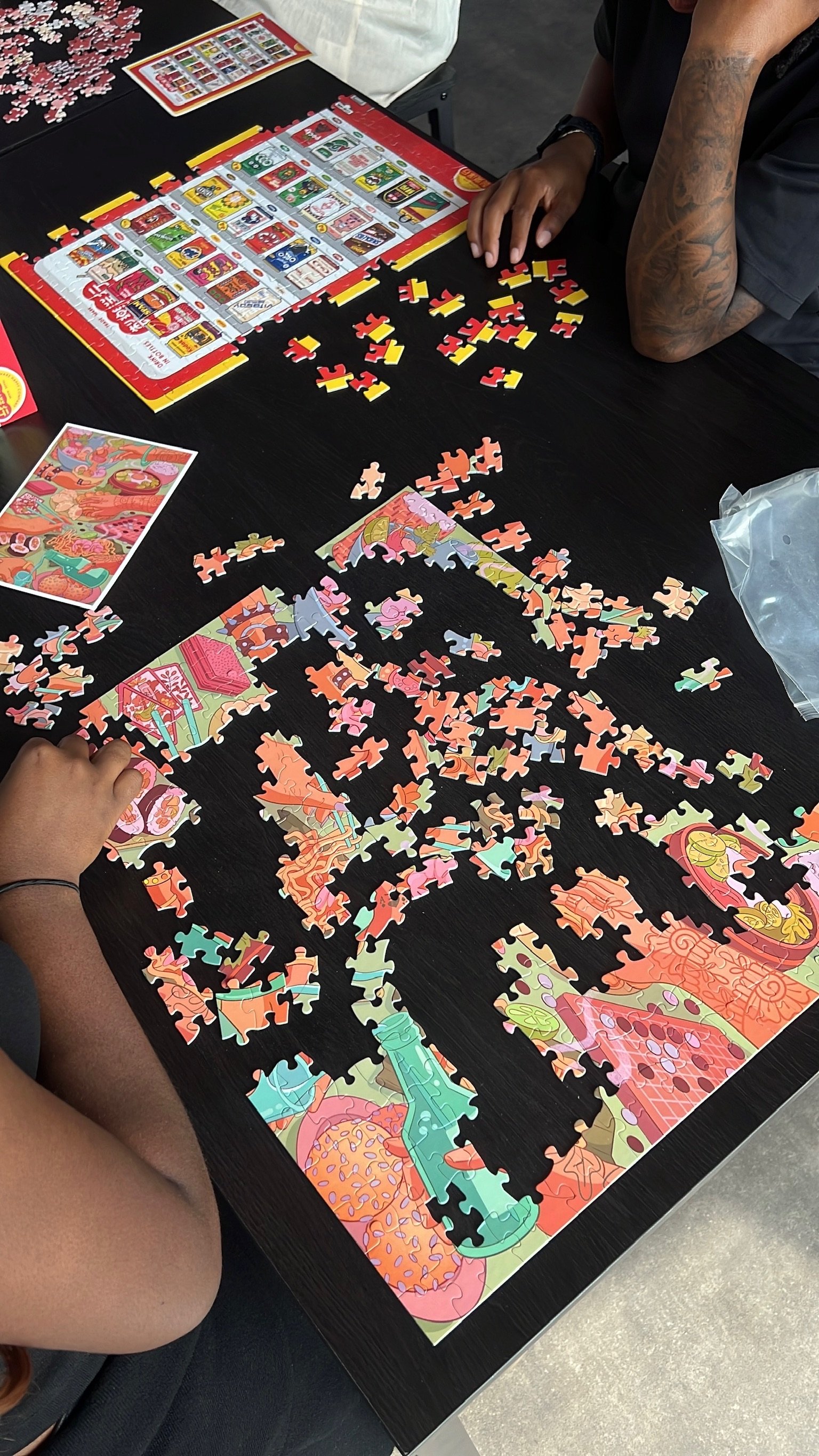 Hands piecing together a colourful puzzle